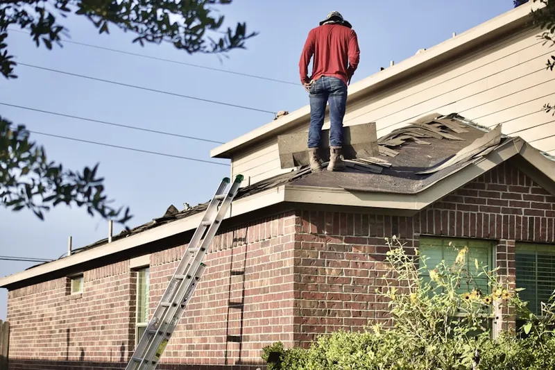 Professional roofer working on a residential roof in North Overland Park Hills